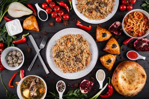 The concept of Eastern festive cuisine. Assorted Uzbek food set, pilaf, samsa Stock Photos