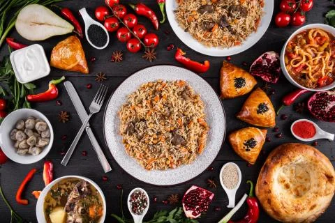 The concept of Eastern festive cuisine. Assorted Uzbek food set, pilaf, samsa Stock Photos