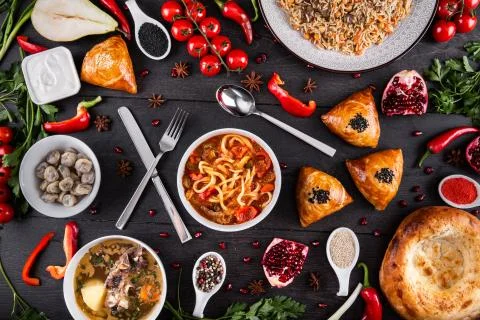 The concept of Eastern festive cuisine. Assorted Uzbek food set, pilaf, samsa Stock Photos