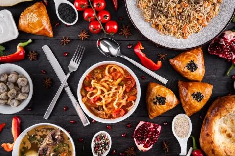 The concept of Eastern festive cuisine. Assorted Uzbek food set, pilaf, samsa Stock Photos