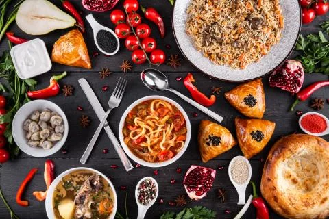 The concept of Eastern festive cuisine. Assorted Uzbek food set, pilaf, samsa Stock Photos