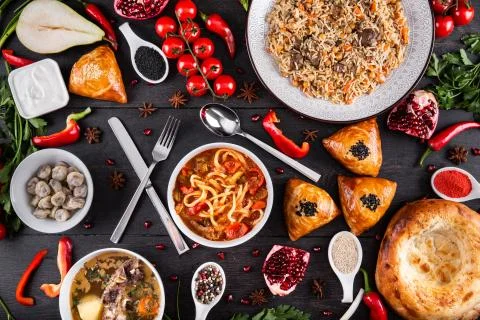 The concept of Eastern festive cuisine. Assorted Uzbek food set, pilaf, samsa Stock Photos