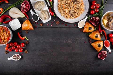 The concept of Eastern festive cuisine. Assorted Uzbek food set, pilaf, samsa Stock Photos