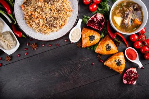 The concept of Eastern festive cuisine. Assorted Uzbek food set, pilaf, samsa Stock Photos