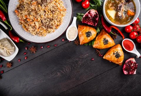 The concept of Eastern festive cuisine. Assorted Uzbek food set, pilaf, samsa Stock Photos
