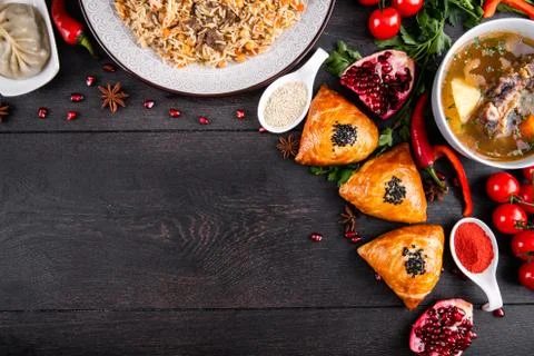 The concept of Eastern festive cuisine. Assorted Uzbek food set, pilaf, samsa Stock Photos