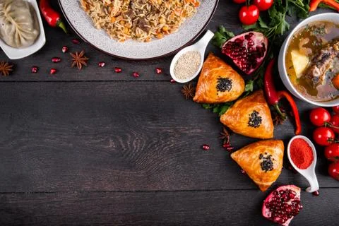 The concept of Eastern festive cuisine. Assorted Uzbek food set, pilaf, samsa Stock Photos