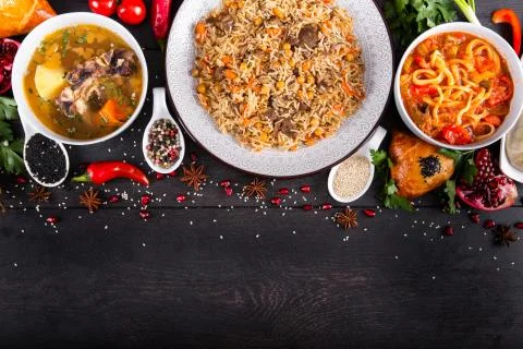 The concept of Eastern festive cuisine. Assorted Uzbek food set, pilaf, samsa Stock Photos