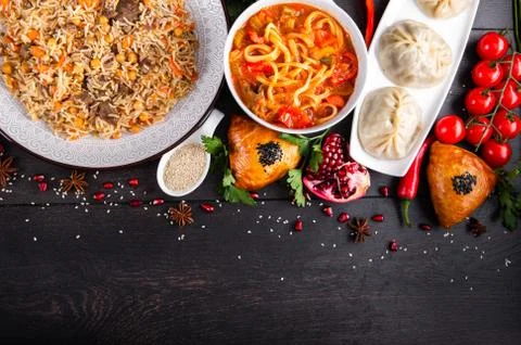 The concept of Eastern festive cuisine. Assorted Uzbek food set, pilaf, samsa Stock Photos