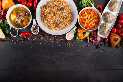 The concept of Eastern festive cuisine. Assorted Uzbek food set, pilaf, samsa Stock Photos