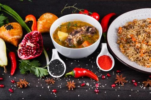 The concept of Eastern festive cuisine. Assorted Uzbek food set, pilaf, samsa Stock Photos