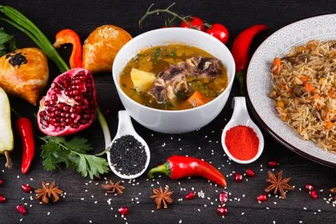 The concept of Eastern festive cuisine. Assorted Uzbek food set, pilaf, samsa Stock Photos