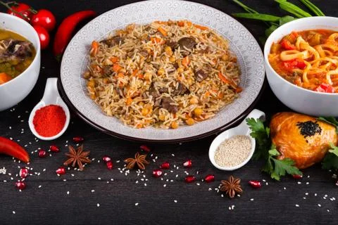 The concept of Eastern festive cuisine. Assorted Uzbek food set, pilaf, samsa Stock Photos