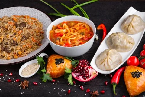 The concept of Eastern festive cuisine. Assorted Uzbek food set, pilaf, samsa Stock Photos