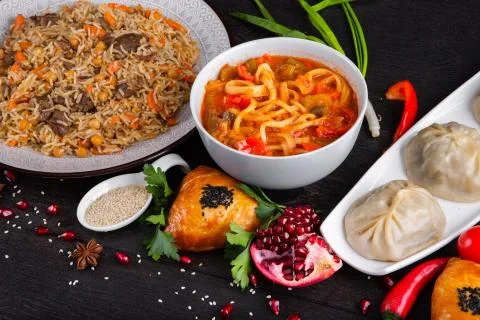 The concept of Eastern festive cuisine. Assorted Uzbek food set, pilaf, samsa Stock Photos