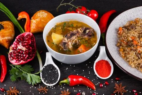 The concept of Eastern festive cuisine. Assorted Uzbek food set, pilaf, samsa Stock Photos
