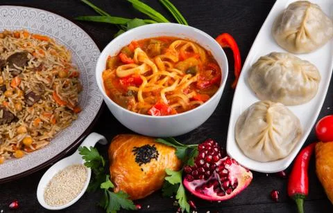The concept of Eastern festive cuisine. Assorted Uzbek food set, pilaf, samsa Stock Photos