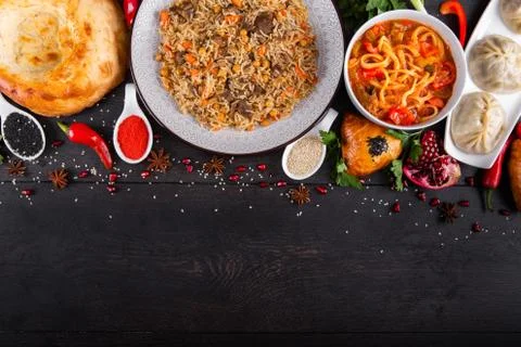 The concept of Eastern festive cuisine. Assorted Uzbek food set, pilaf, samsa Stock Photos
