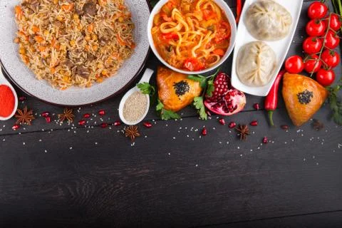 The concept of Eastern festive cuisine. Assorted Uzbek food set, pilaf, samsa Stock Photos
