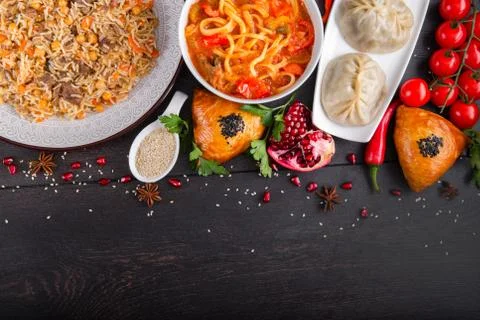 The concept of Eastern festive cuisine. Assorted Uzbek food set, pilaf, samsa Stock Photos