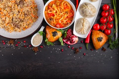 The concept of Eastern festive cuisine. Assorted Uzbek food set, pilaf, samsa Stock Photos