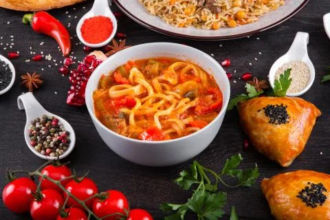 The concept of Eastern festive cuisine. Assorted Uzbek food set, pilaf, samsa Stock Photos