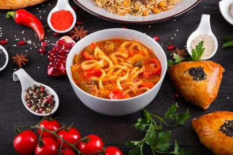 The concept of Eastern festive cuisine. Assorted Uzbek food set, pilaf, samsa Stock Photos