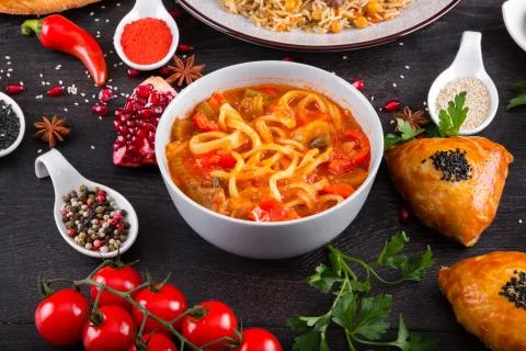The concept of Eastern festive cuisine. Assorted Uzbek food set, pilaf, samsa Stock Photos