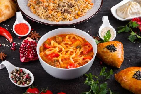 The concept of Eastern festive cuisine. Assorted Uzbek food set, pilaf, samsa Stock Photos