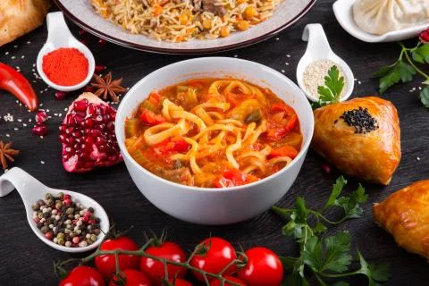 The concept of Eastern festive cuisine. Assorted Uzbek food set, pilaf, samsa Stock Photos