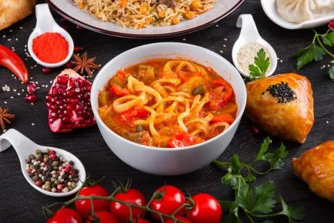 The concept of Eastern festive cuisine. Assorted Uzbek food set, pilaf, samsa Stock Photos