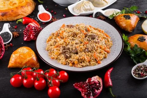 The concept of Eastern festive cuisine. Assorted Uzbek food set, pilaf, samsa Stock Photos