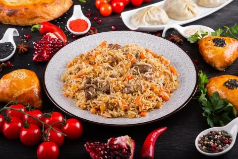 The concept of Eastern festive cuisine. Assorted Uzbek food set, pilaf, samsa Stock Photos