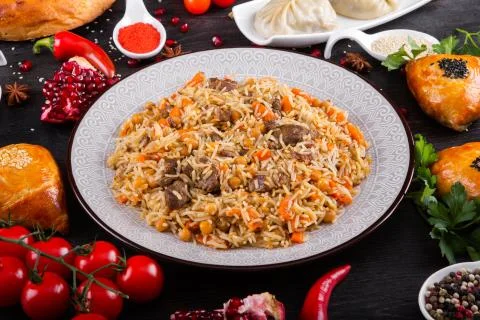 The concept of Eastern festive cuisine. Assorted Uzbek food set, pilaf, samsa Stock Photos