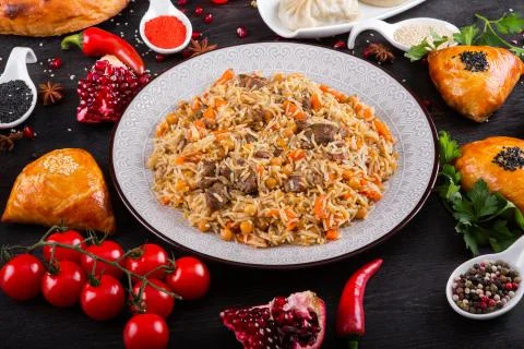 The concept of Eastern festive cuisine. Assorted Uzbek food set, pilaf, samsa Stock Photos