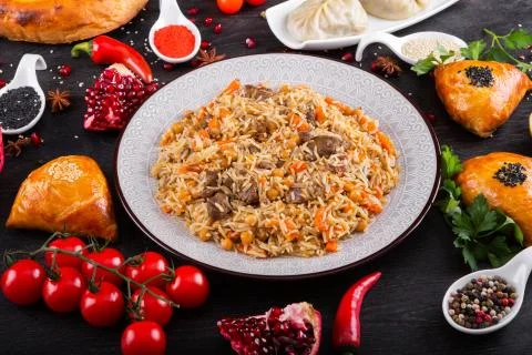 The concept of Eastern festive cuisine. Assorted Uzbek food set, pilaf, samsa Stock-Fotos