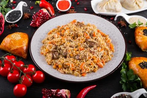 The concept of Eastern festive cuisine. Assorted Uzbek food set, pilaf, samsa Stock Photos