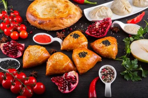 The concept of Eastern festive cuisine. Assorted Uzbek food set, pilaf, samsa Stock-Fotos