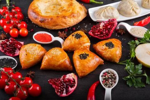 The concept of Eastern festive cuisine. Assorted Uzbek food set, pilaf, samsa Stock Photos