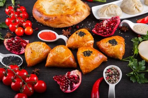 The concept of Eastern festive cuisine. Assorted Uzbek food set, pilaf, samsa Stock Photos