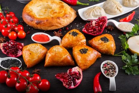 The concept of Eastern festive cuisine. Assorted Uzbek food set, pilaf, samsa Stock Photos