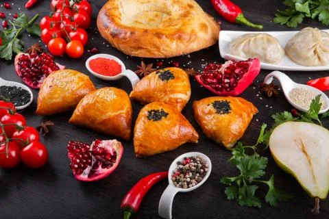 The concept of Eastern festive cuisine. Assorted Uzbek food set, pilaf, samsa Stock Photos