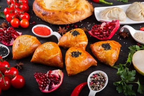 The concept of Eastern festive cuisine. Assorted Uzbek food set, pilaf, samsa Stock Photos