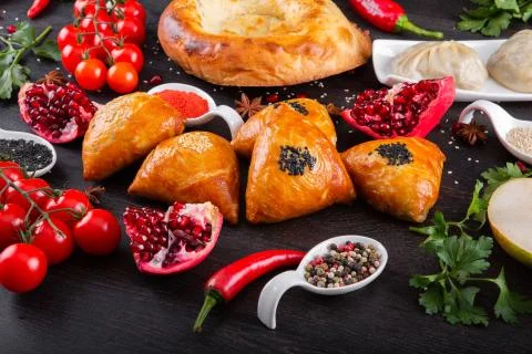 The concept of Eastern festive cuisine. Assorted Uzbek food set, pilaf, samsa Stock Photos