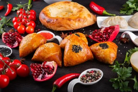 The concept of Eastern festive cuisine. Assorted Uzbek food set, pilaf, samsa Stock Photos