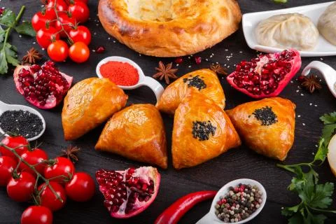 The concept of Eastern festive cuisine. Assorted Uzbek food set, pilaf, samsa Stock Photos