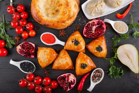 The concept of Eastern festive cuisine. Assorted Uzbek food set, pilaf, samsa Stock Photos