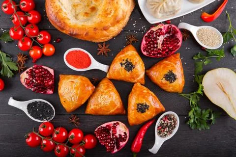 The concept of Eastern festive cuisine. Assorted Uzbek food set, pilaf, samsa Stock Photos