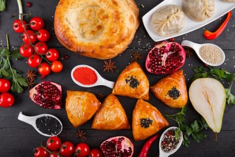 The concept of Eastern festive cuisine. Assorted Uzbek food set, pilaf, samsa Stock Photos