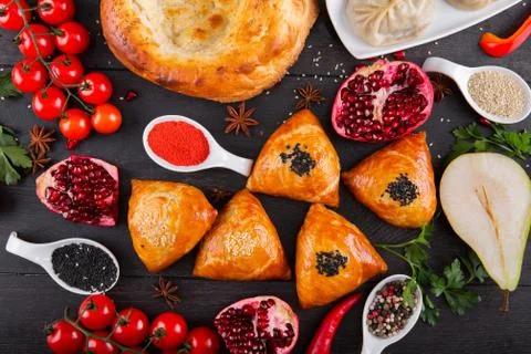 The concept of Eastern festive cuisine. Assorted Uzbek food set, pilaf, samsa Stock Photos